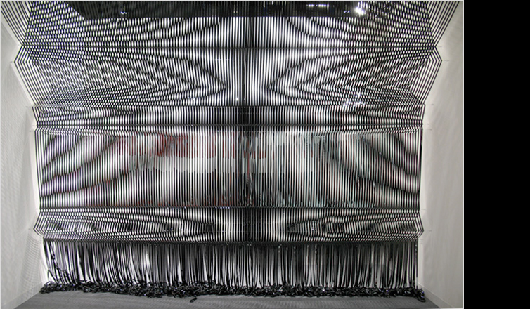Large textures created from unspooled video tapes at an art gallery