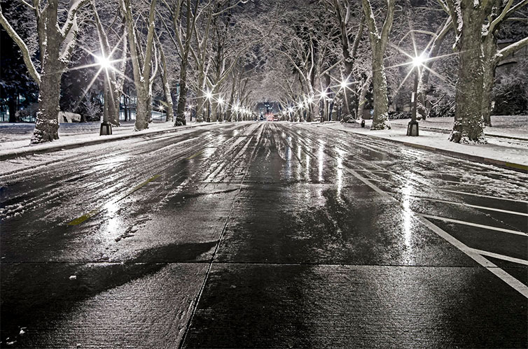 snow covered street at night